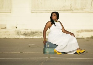african-american-woman-sitting-on-suitcases